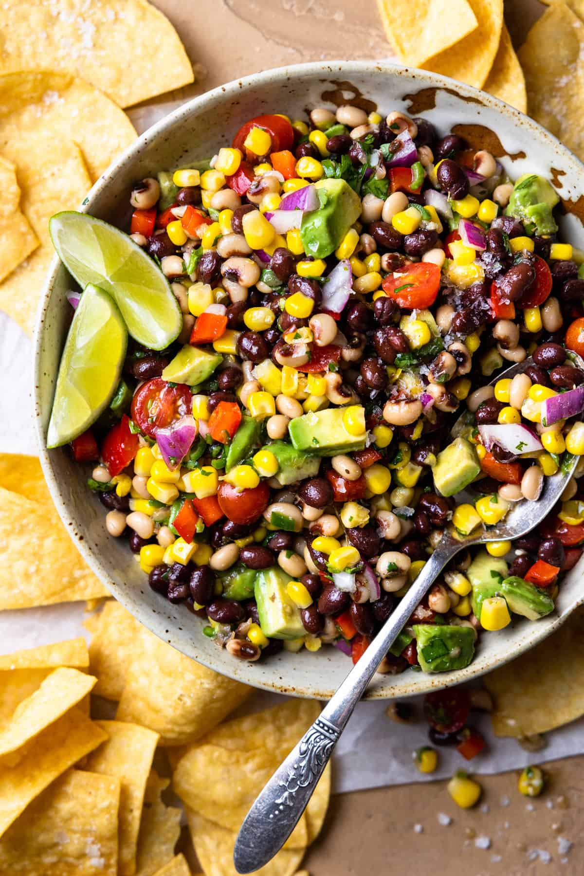 Bowl of Texas Caviar black eyed pea dip served with lime garnish.