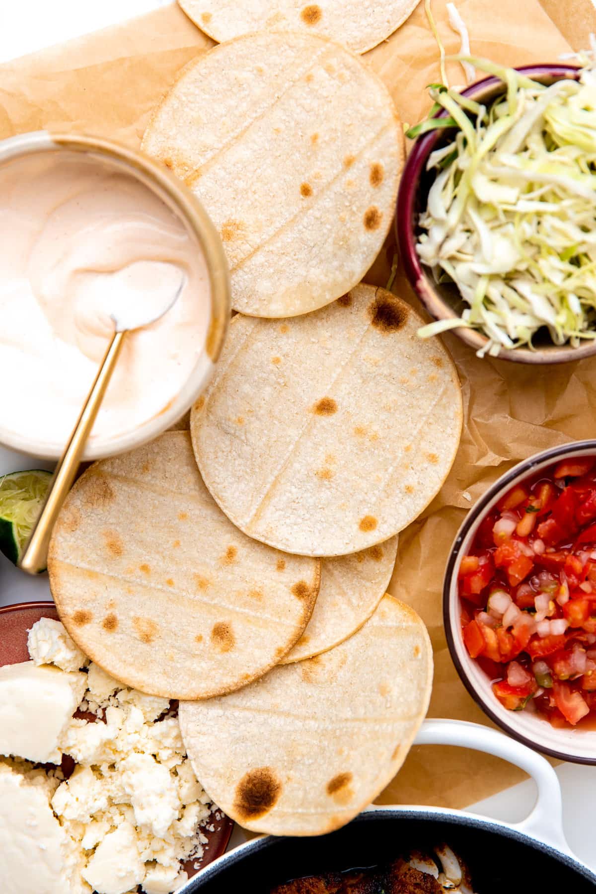 Ingredients for assembling fish tacos laid out.