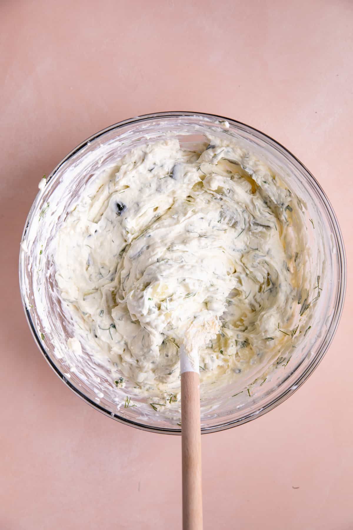 Bowl of dill pickle dip with cream cheese just mixed in a bowl.