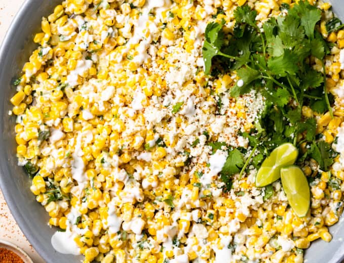 Serving bowl filled with creamy elote corn salad.