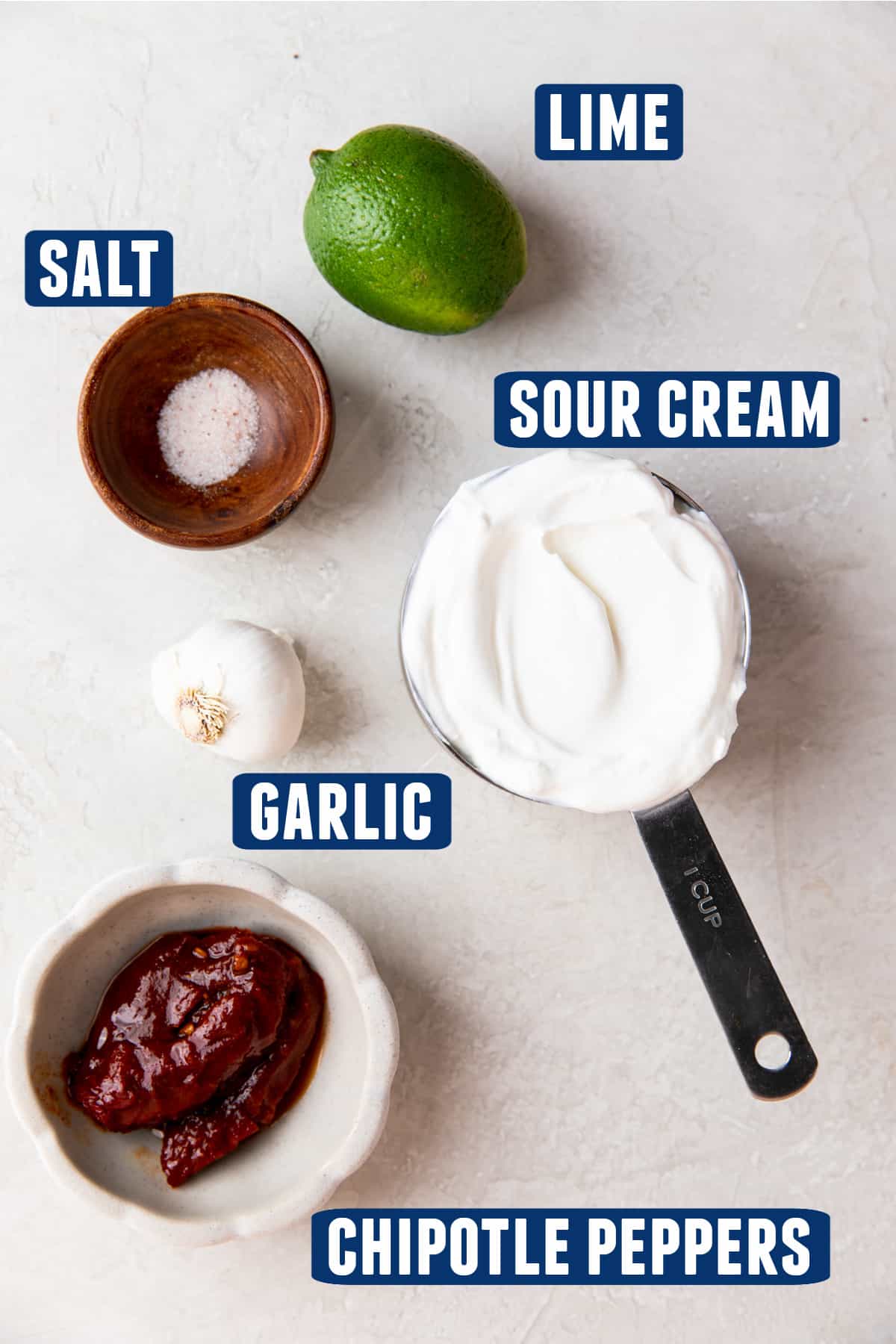 Ingredients needed to make chipotle crema laid out on the counter. 