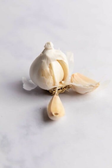 Garlic bulb split apart showing individual cloves.