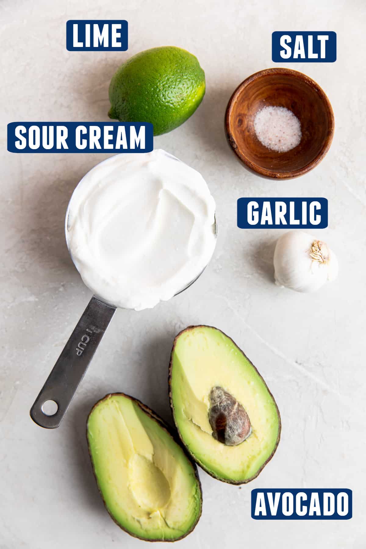 Ingredients needed to make avocado crema laid out on the counter. 