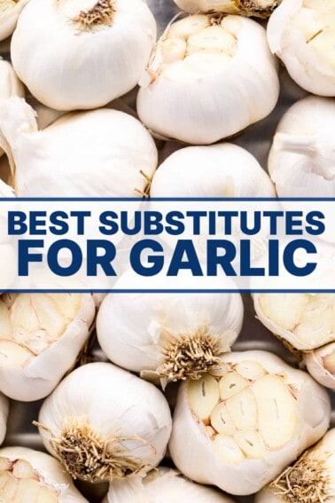Garlic bulbs spread out, some with tip cut off to reveal cloves inside.