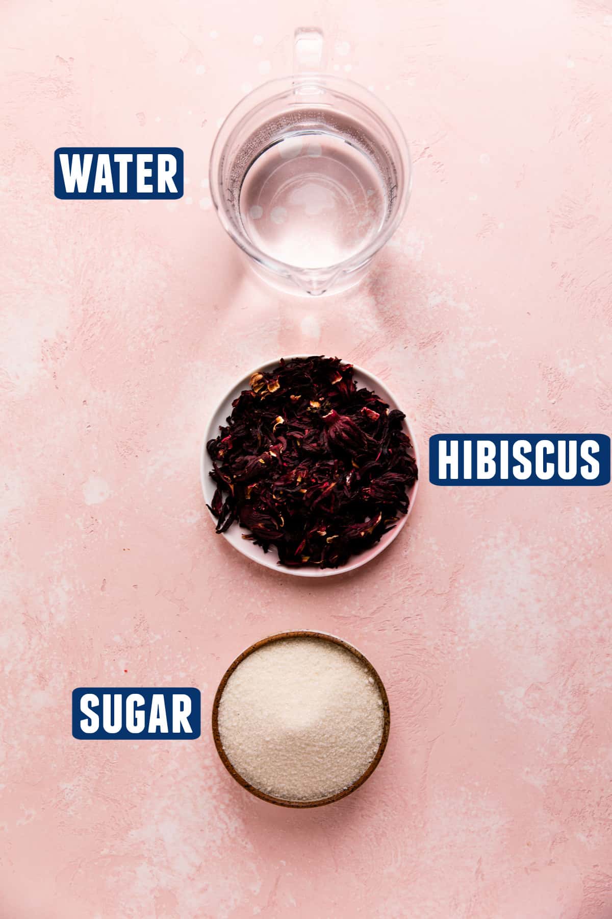 Ingredients needed to make a hibiscus simple syrup laid on the counter. 
