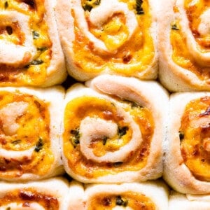 Up close view of fluffy cheese rolls with diced jalapeno.