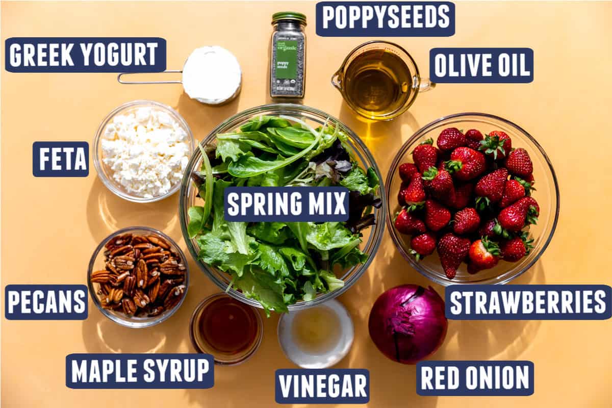 Ingredients needed to make a strawberry salad with poppyseed dressing laid out on the counter. 