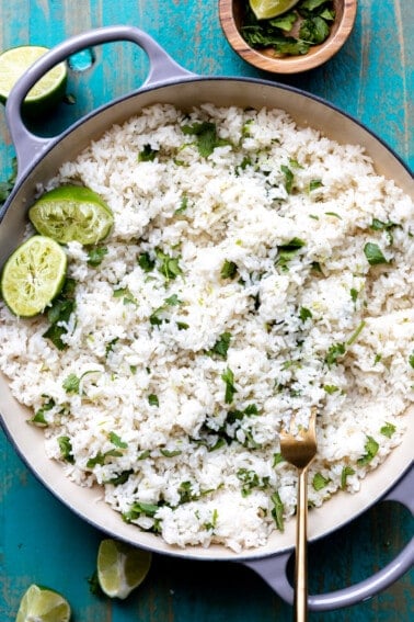 Cast iron pot filled with cooked white cilantro lime rice.
