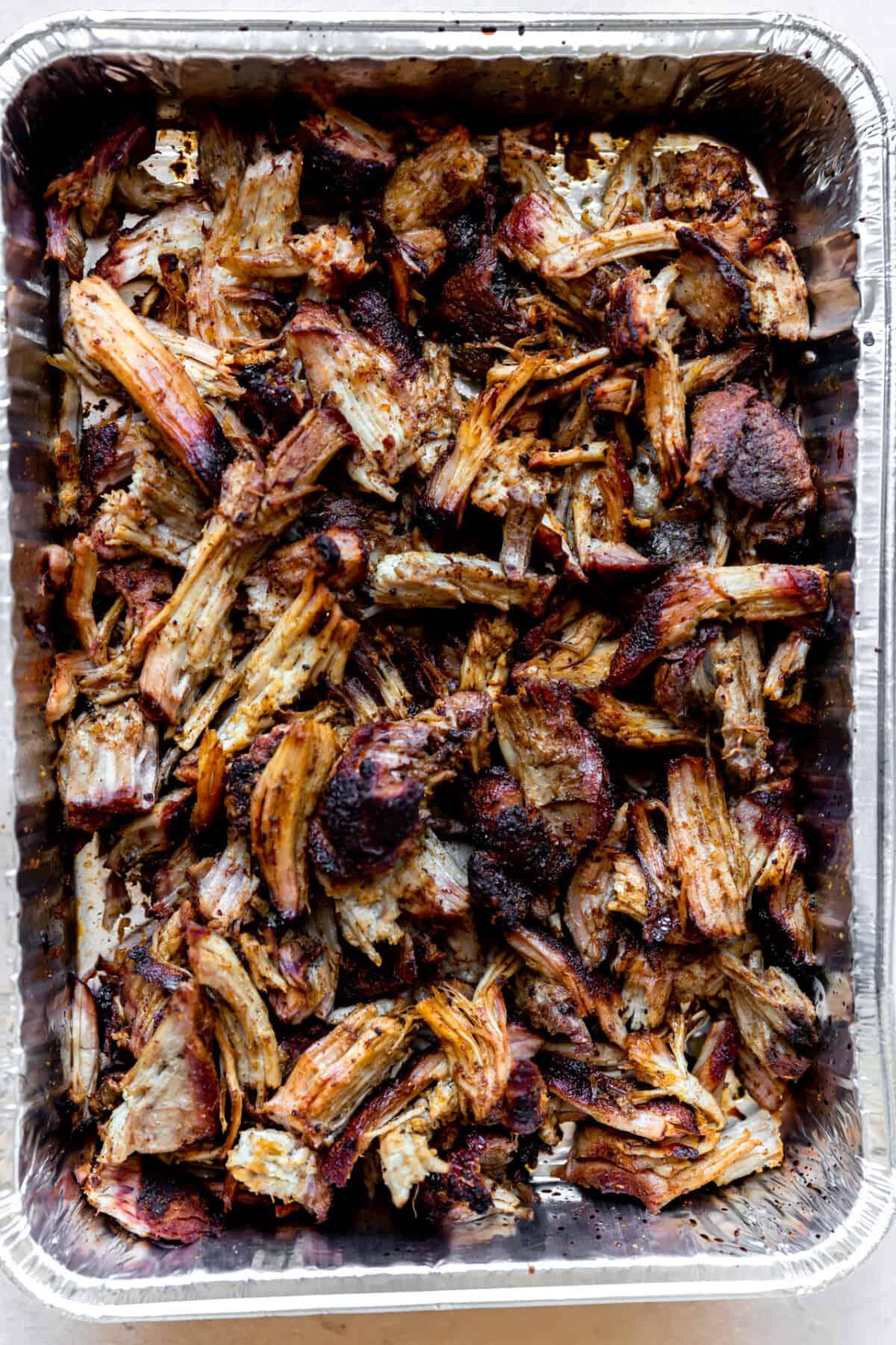 Shredded pork in a tin after smoking.