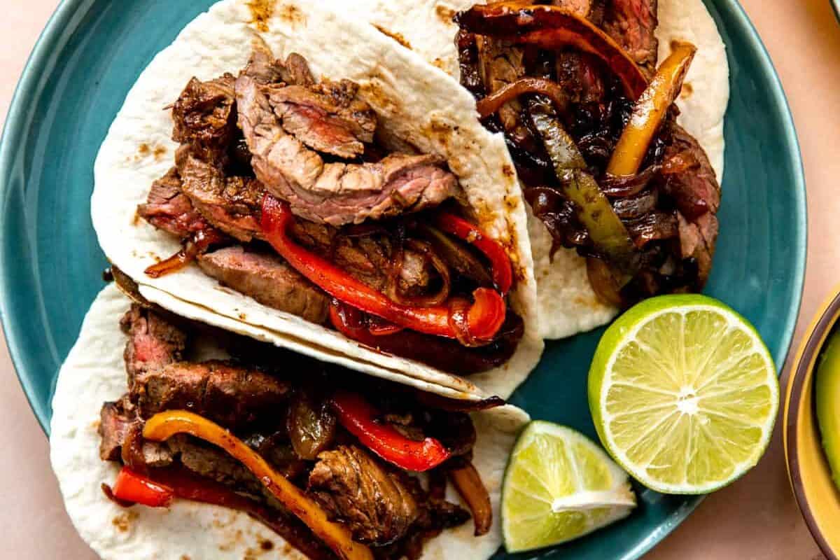 Steak fajitas served in flour tortillas.