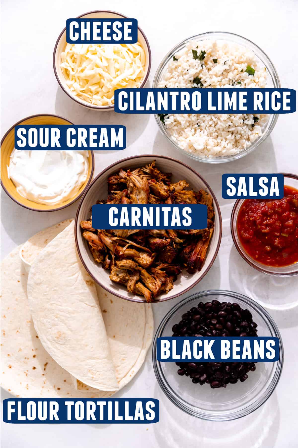 Ingredients needed to make carnitas burritos laid out on the counter. 