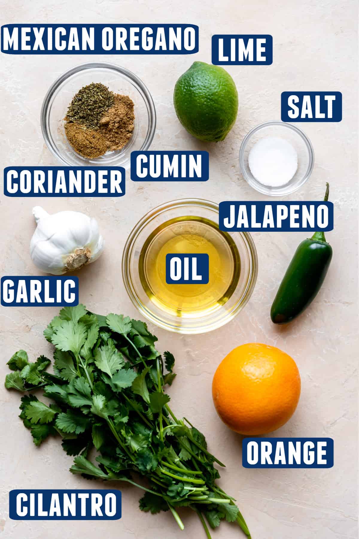 Ingredients needed to make a carnitas marinade laid on the counter. 