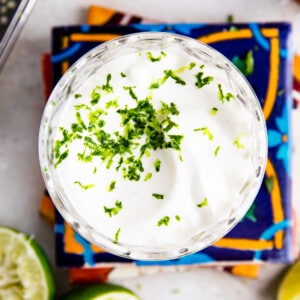 Glass filled with smooth Lime Crema topped with lime zest. Sitting on top of mexican tiles.