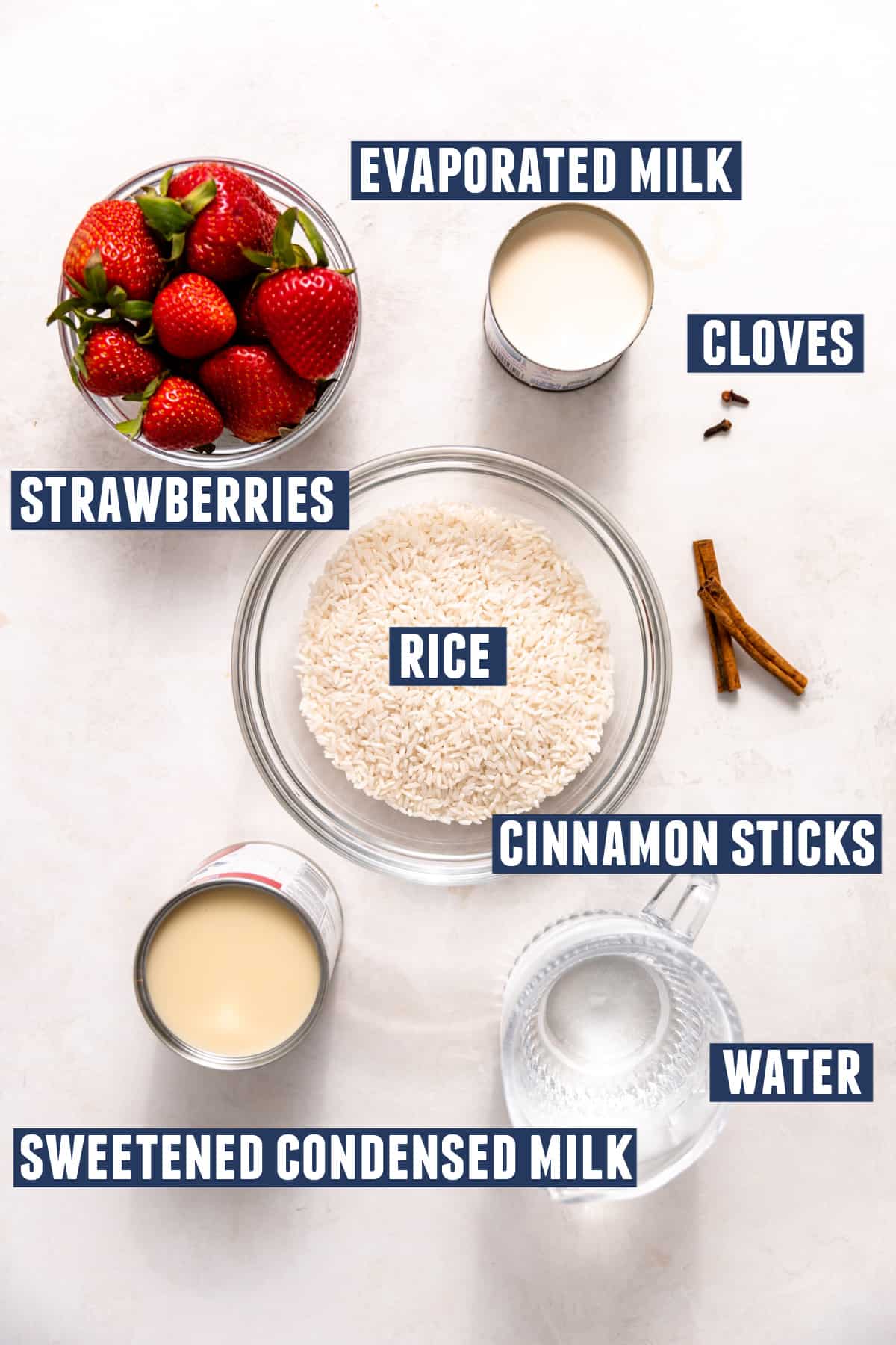Ingredients needed to make strawberry horchata laid on a counter.