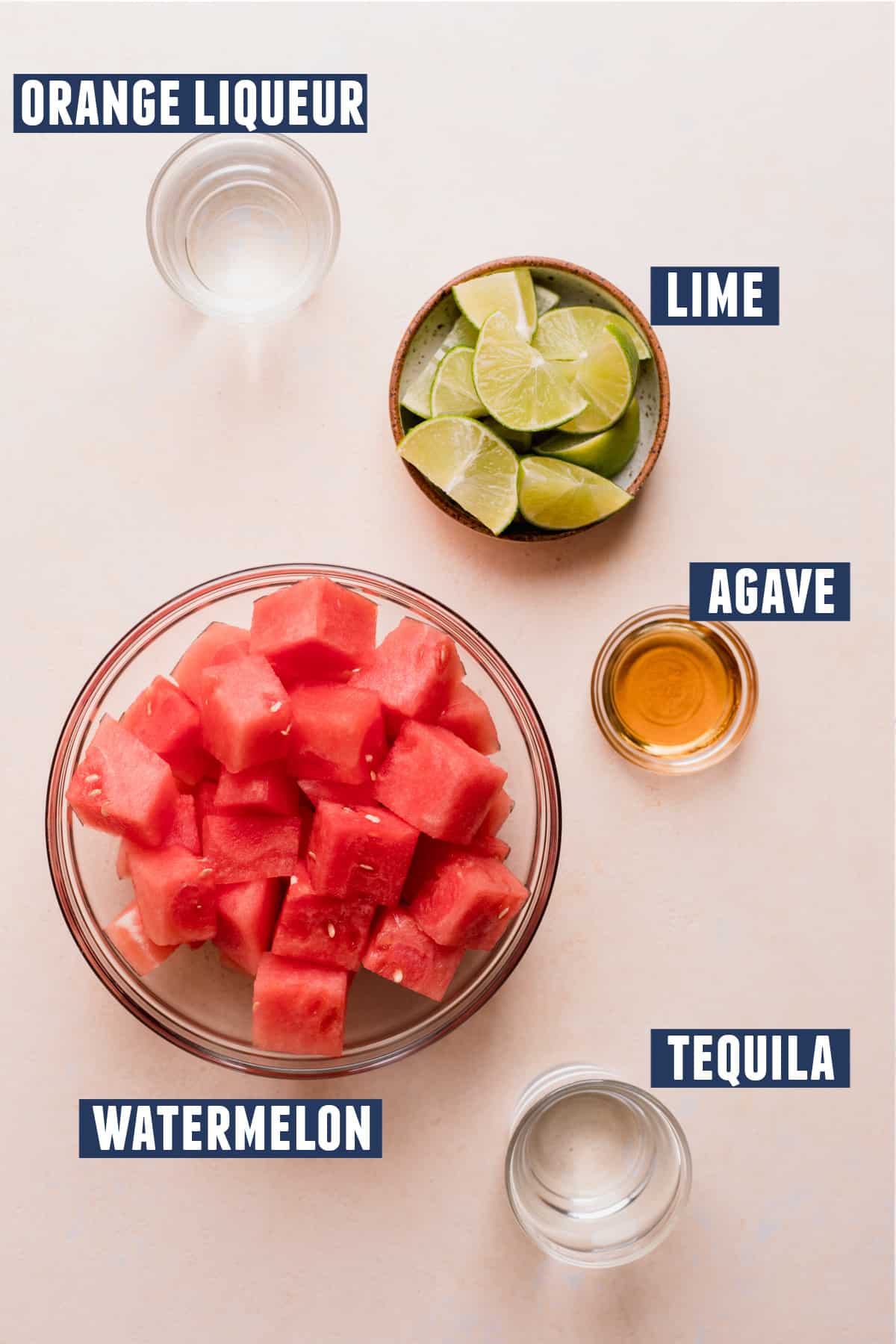 Ingredients needed to make a watermelon margarita laid on the counter. 