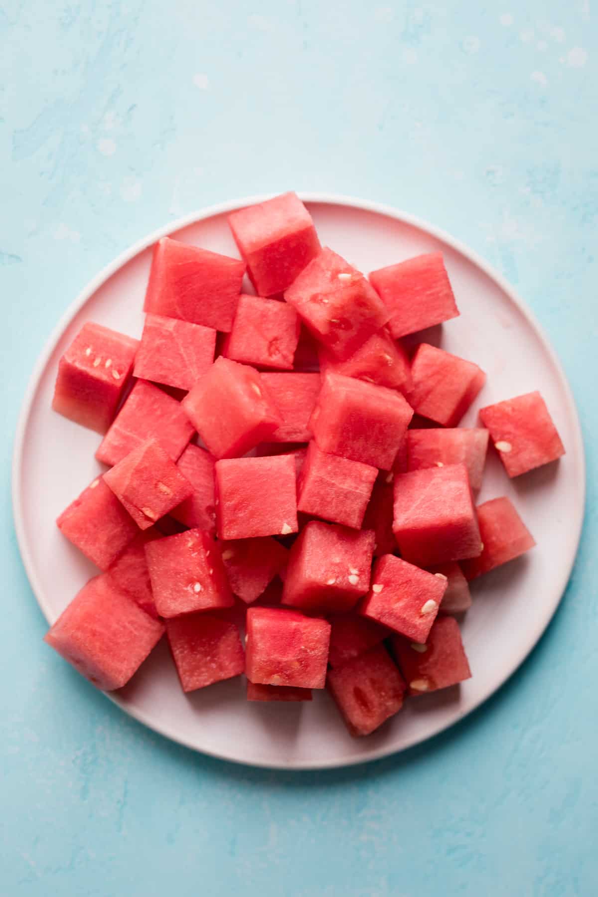 White plate with cubed watermelon.