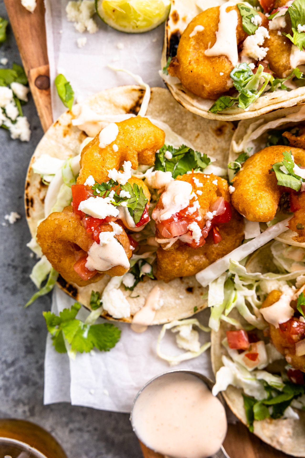 Corn tortillas loaded up with crispy slaw, fried shrimp and drizzled with fish taco sauce.