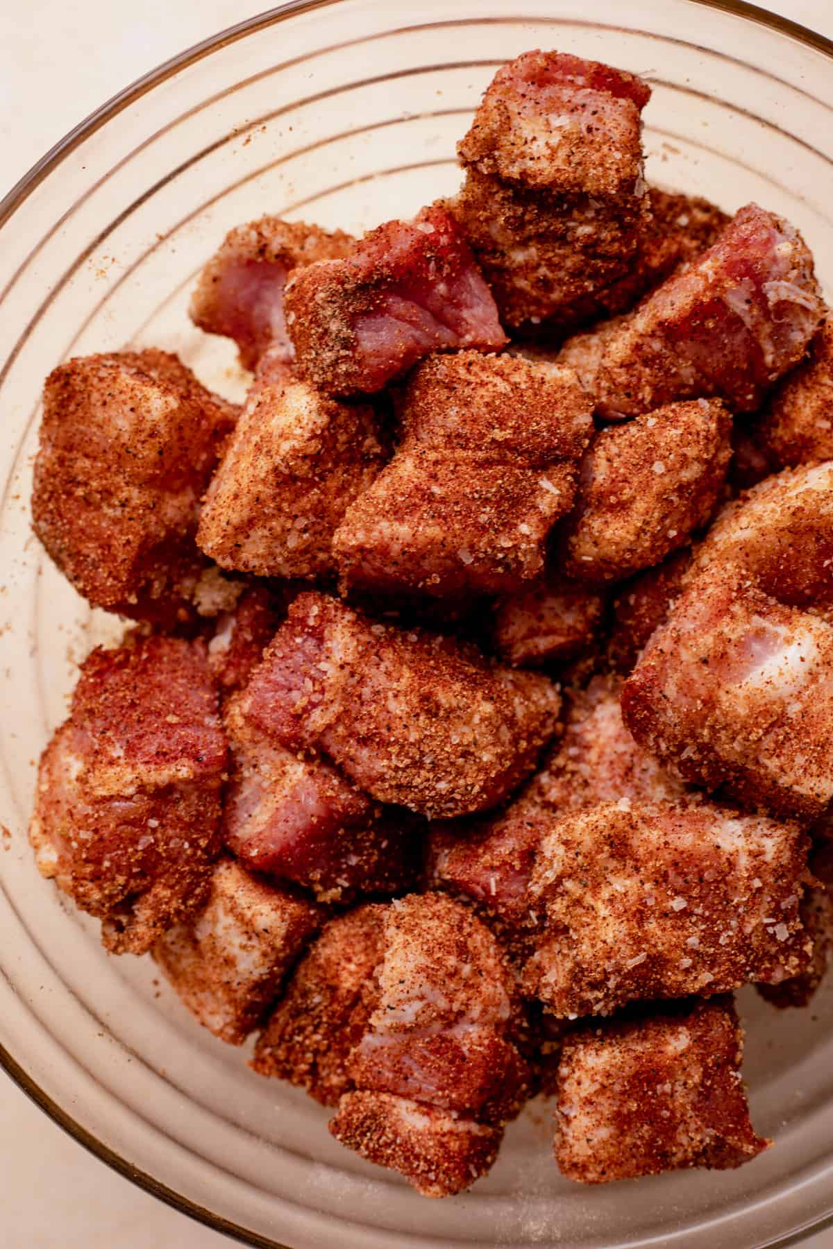 Bowl of cubed pork belly coated in a seasoning rub.