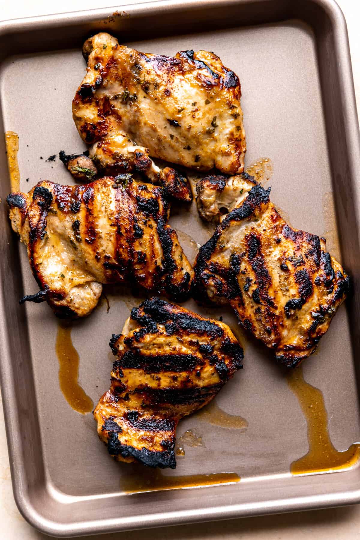 Cooked chicken on baking sheet after cooking.