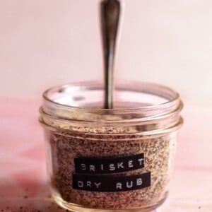 Small glass jar filled with spice mix and a label of Brisket Dry Rub.