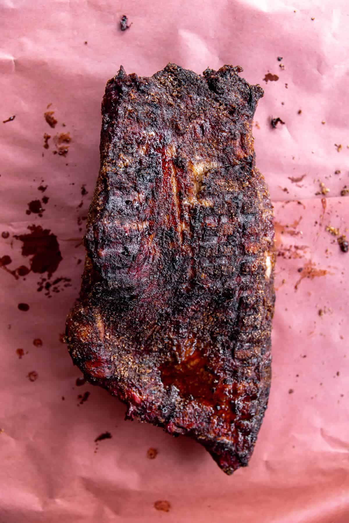 Smoked brisket laid on a piece of butcher paper.