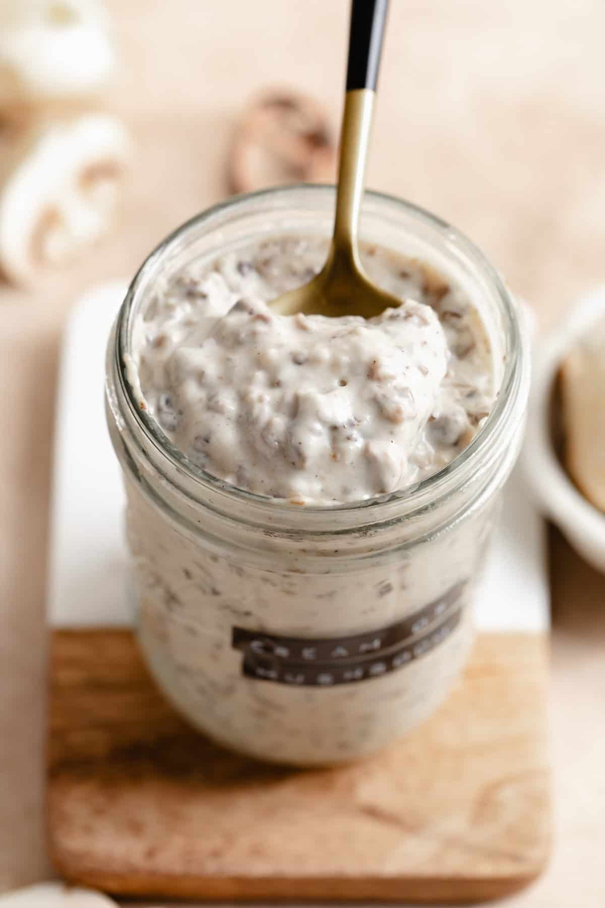 Jar of cream of mushroom soup with a spoon.