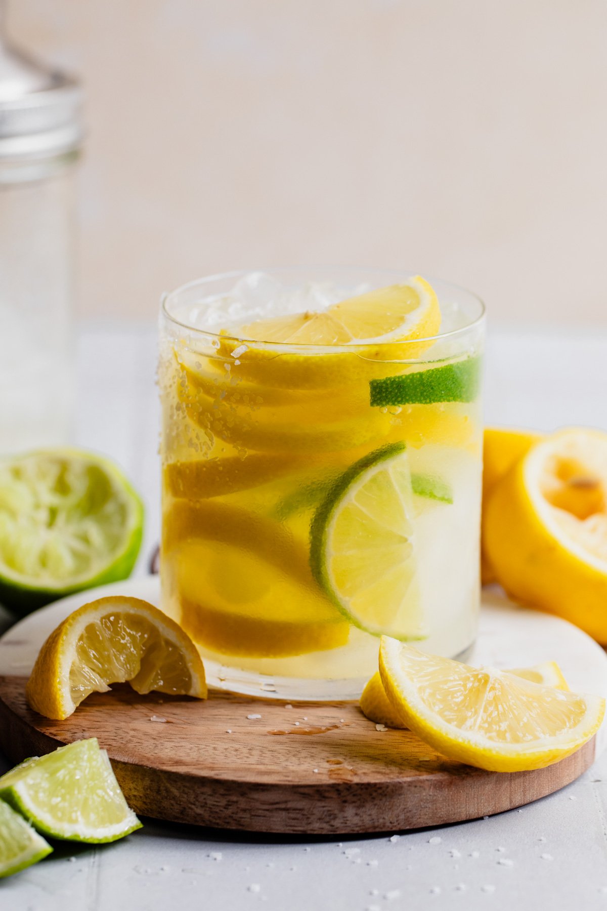 Glass filled with lemon slices and lemon margarita.