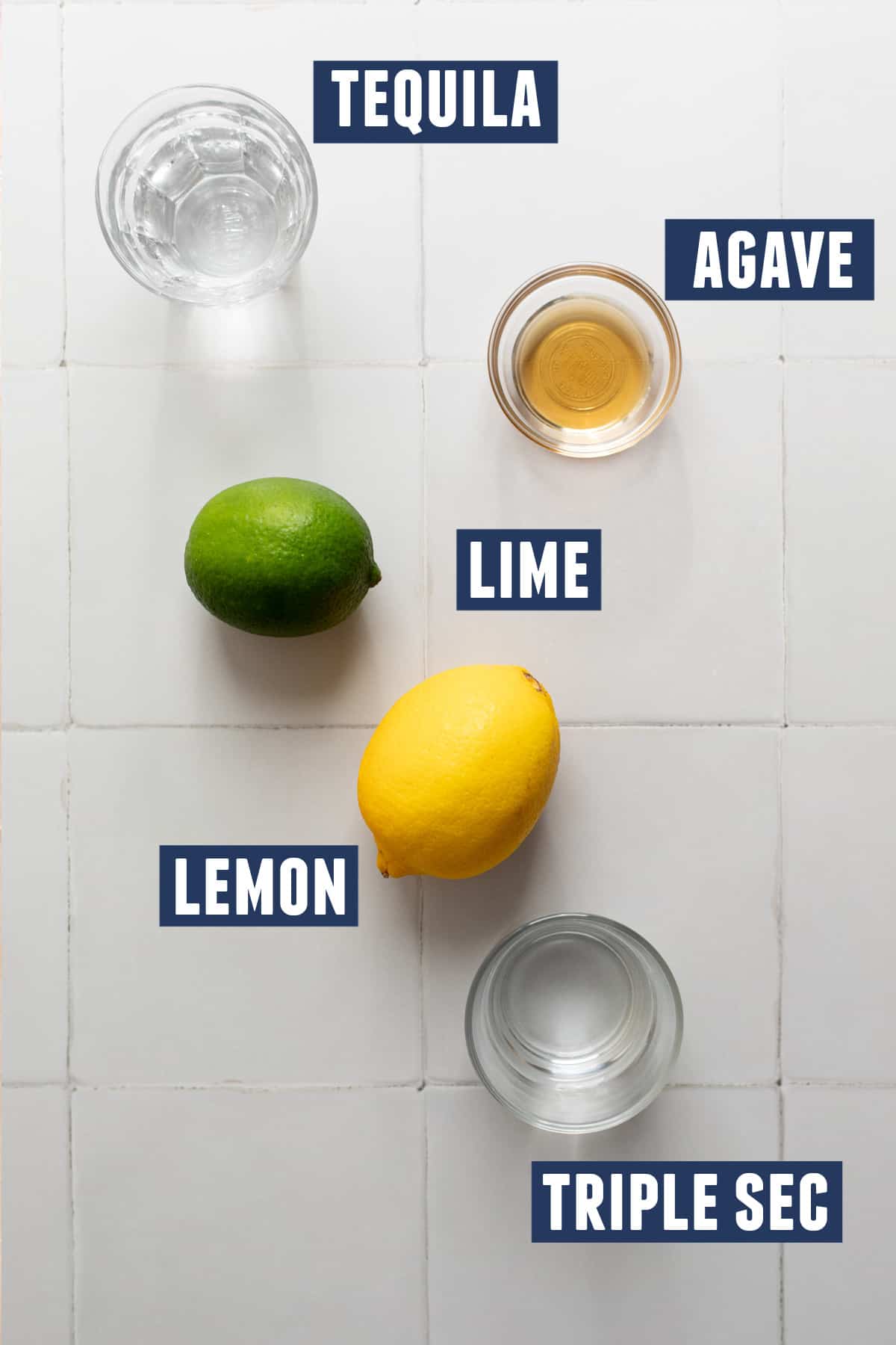 Ingredients needed to make a lemon margarita laid out on the counter. 