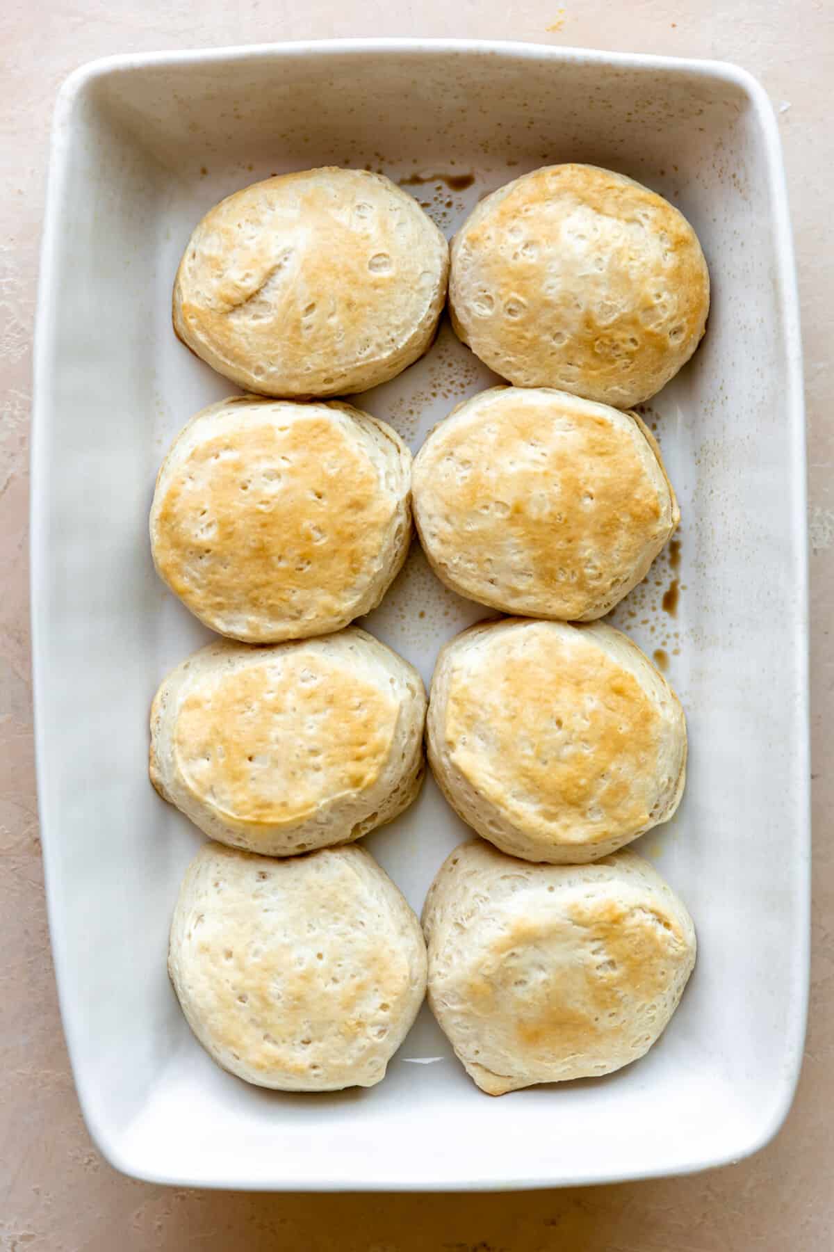Baked biscuits in a white baking dish. 