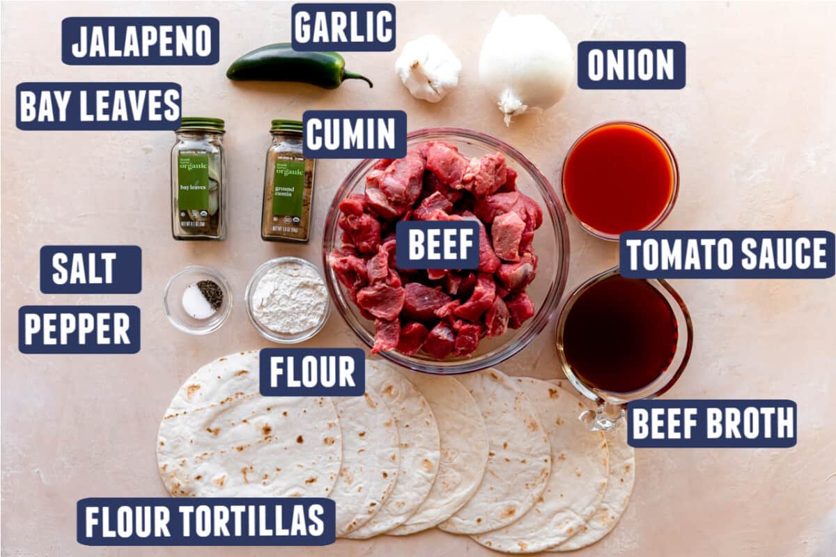 Ingredients needed to make carne guisada laid out on the counter. 