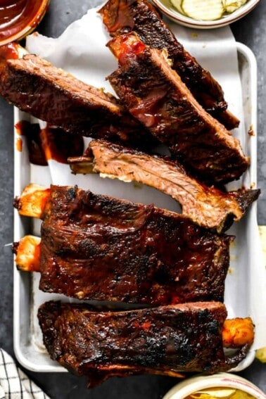 White plate serving beef ribs cooked in the oven.