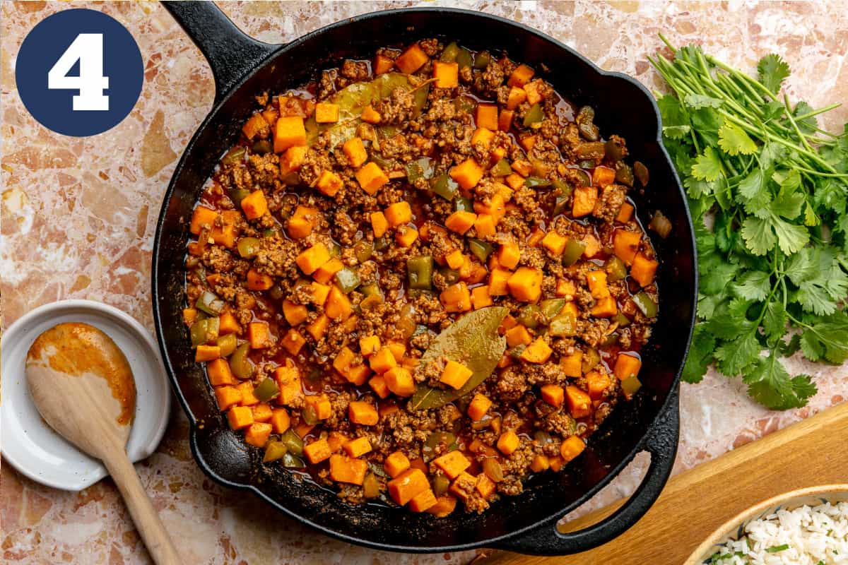 Cooked sweet potato and ground beef meal in a cast iron skillet. 