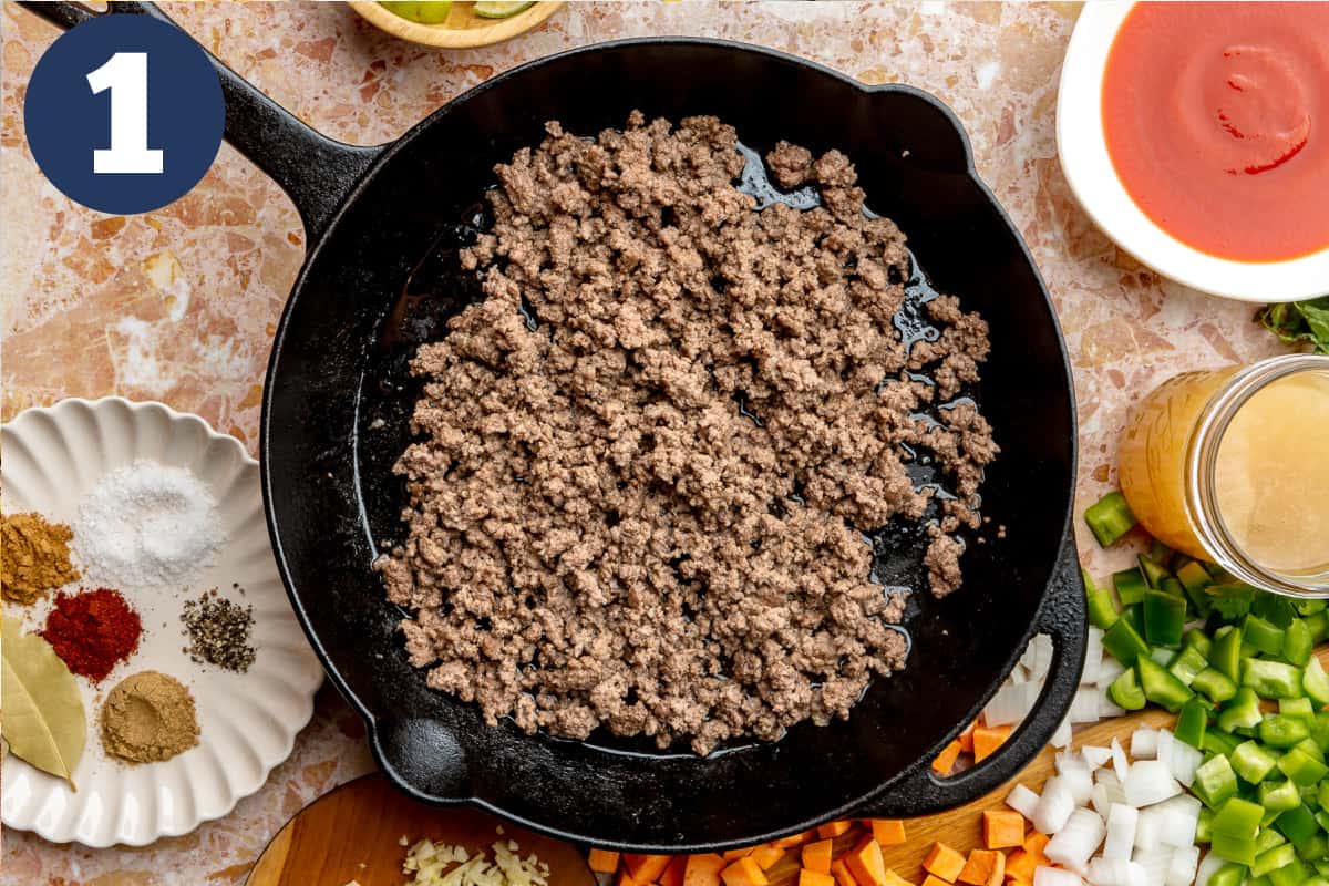 Ground beef browned in a cast iron skillet. 