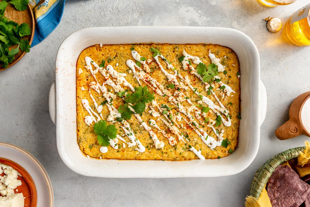 White baking dish with baked Mexican corn casserole. 