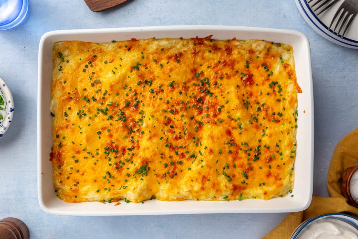 Baked Cheesy Mashed potatoes in a white baking dish. 