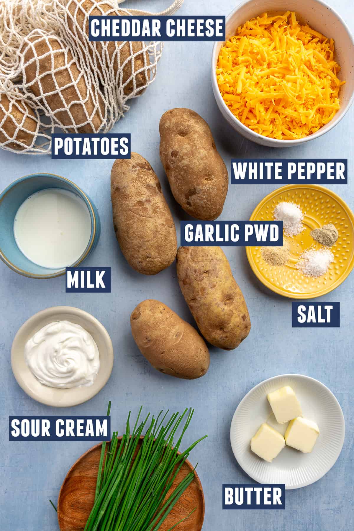 Ingredients needed to make cheesy mashed potatoes laid on the counter. 