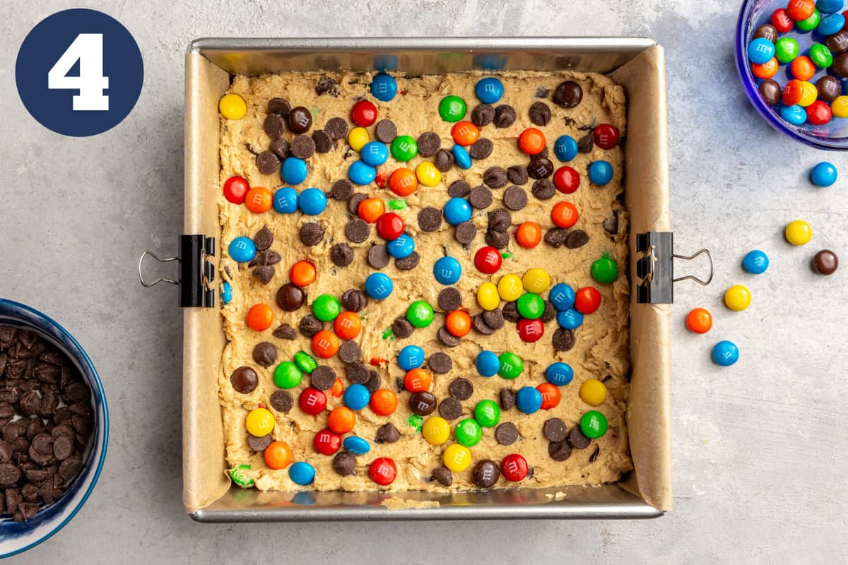 Monster cookie bar dough pressed into a baking pan before baking.