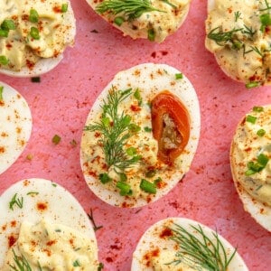 Deviled eggs topped with fresh dill and pickled jalapeño slices.
