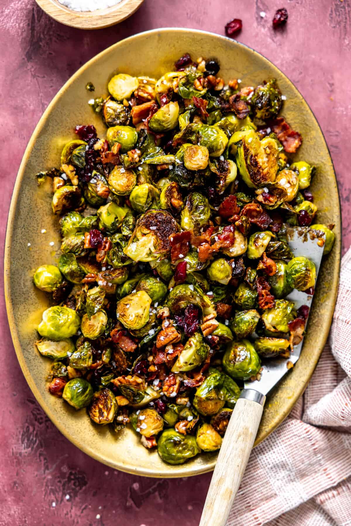Serving dish with roasted brussels sprouts with bacon. 