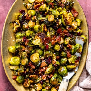 Serving dish with roasted brussels sprouts with bacon.