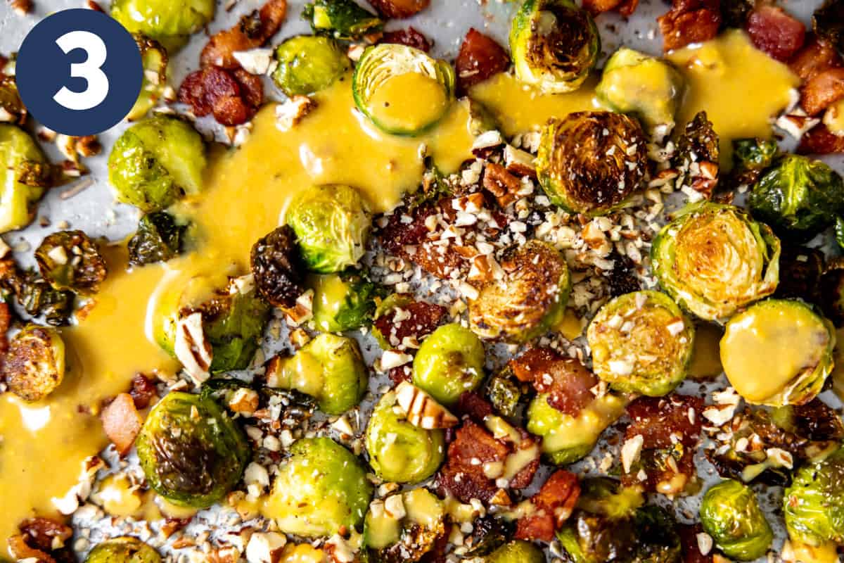 Dijon maple sauce spread across roasted brussels sprouts. 