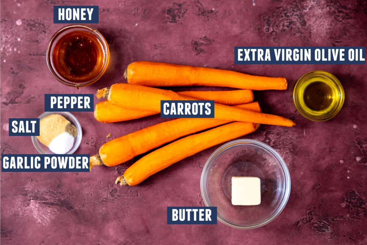 Ingredients needed to make roasted carrots laid out on the counter. 