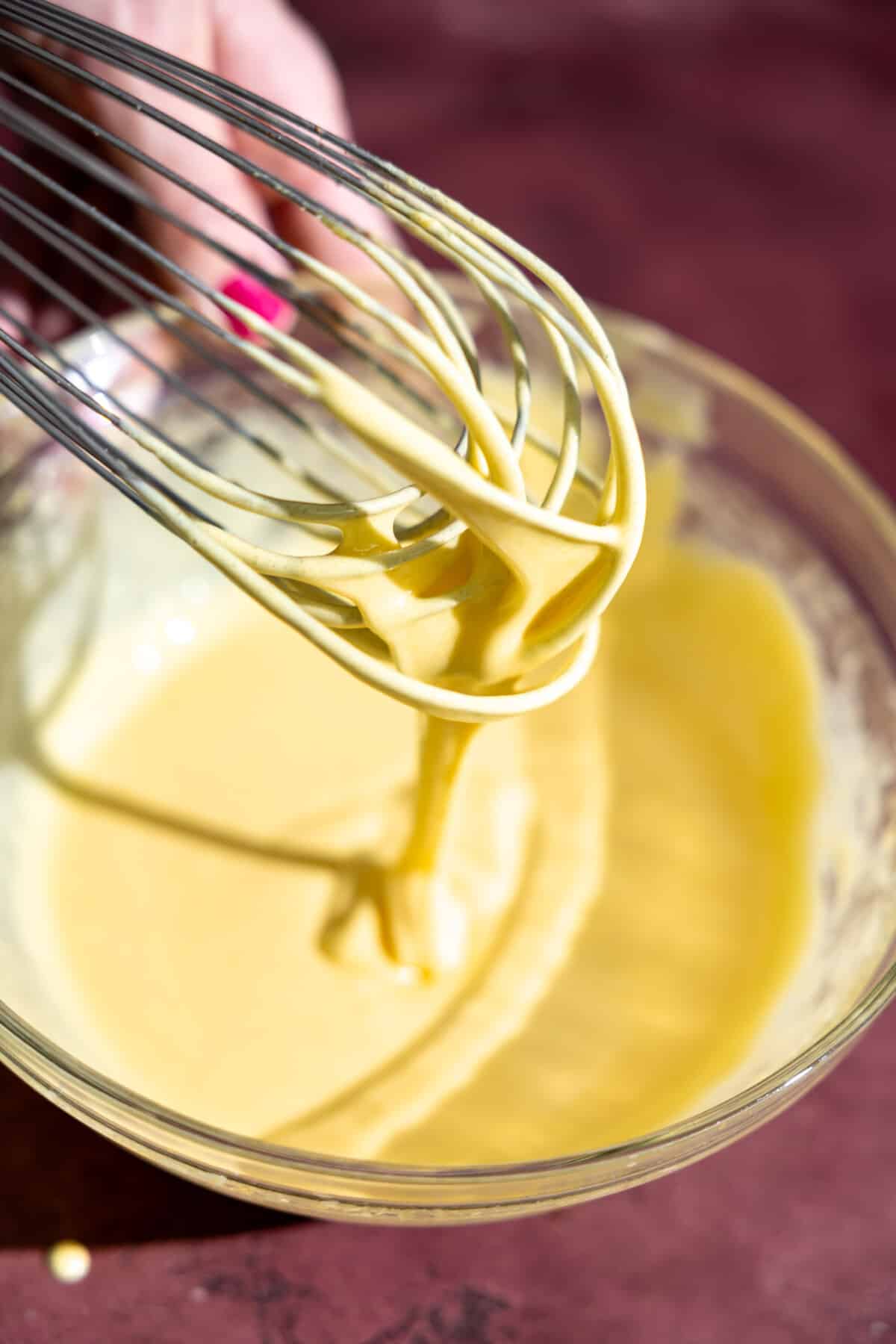 Egg yolks and sugar being whisked.