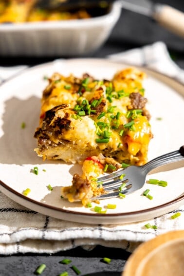 Slice of hashbrown breakfast casserole served on a plate.