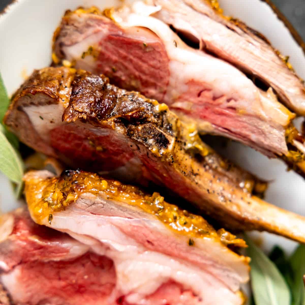 Sliced rack of lamb on a plate.