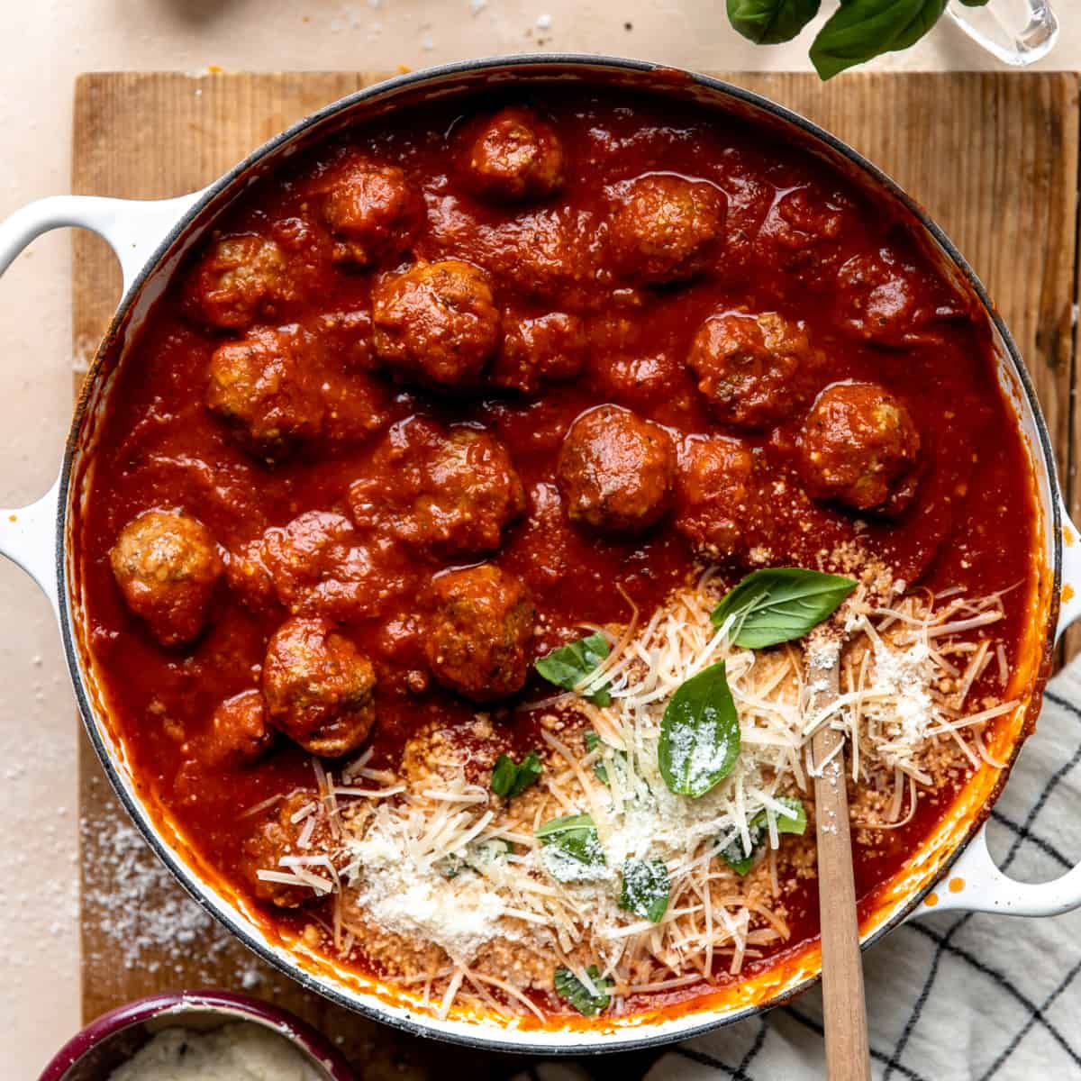 Meatballs in a skillet with parmesan.
