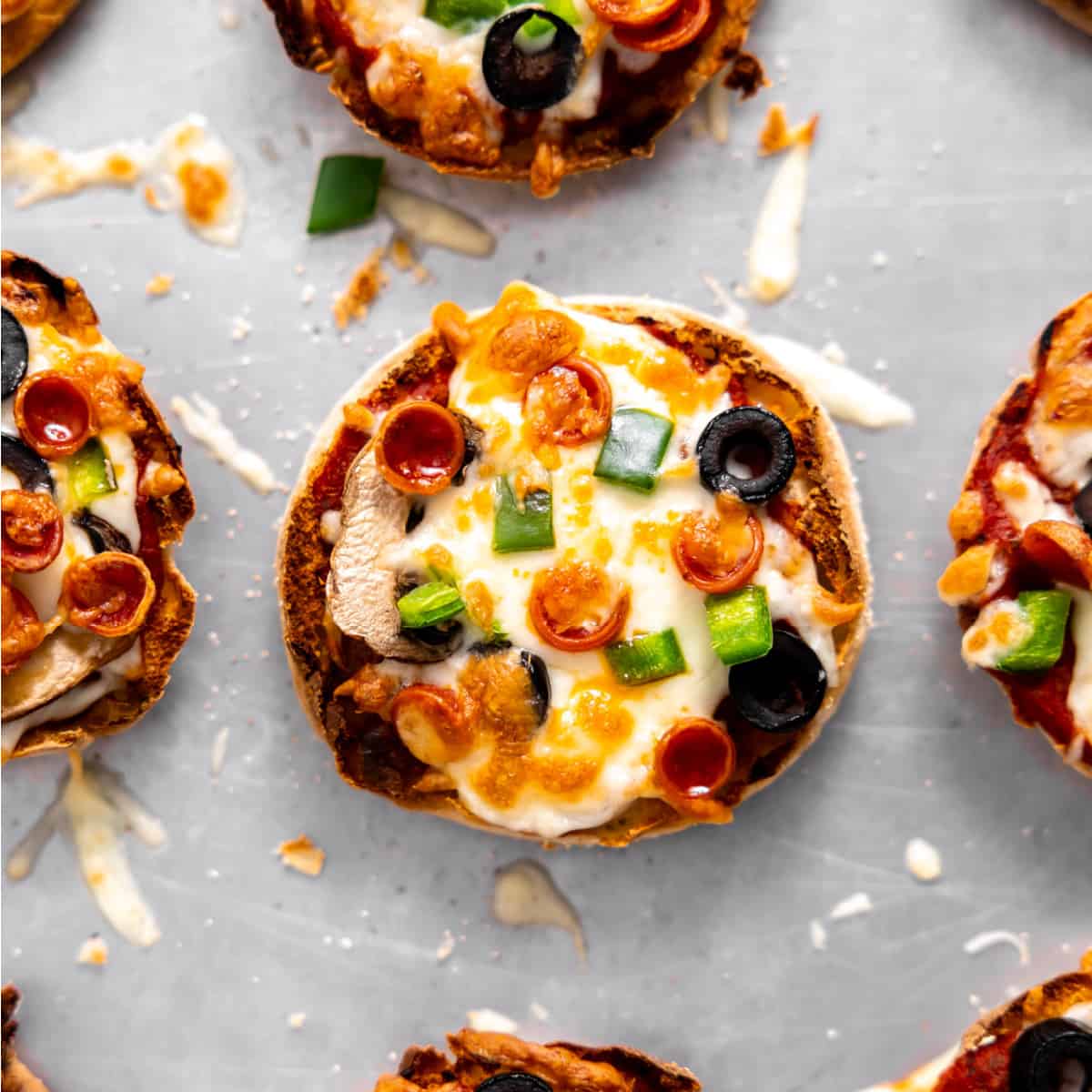 English muffin pizza baked with cheese, pepperoni, olives, bell pepper and mushrooms. 
