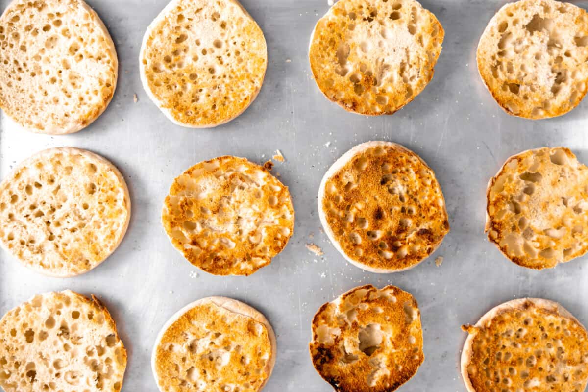 Toasted English muffins on a tray.