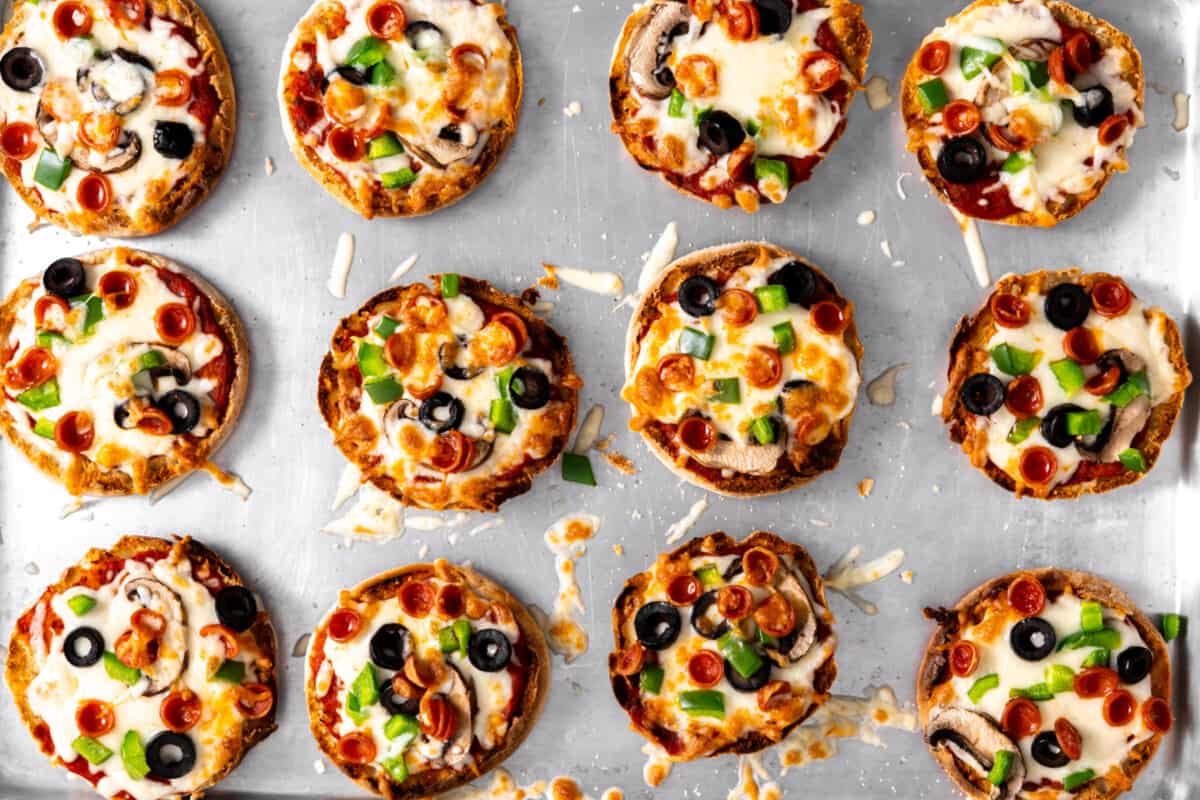 Tray of baked English muffin pizzas.