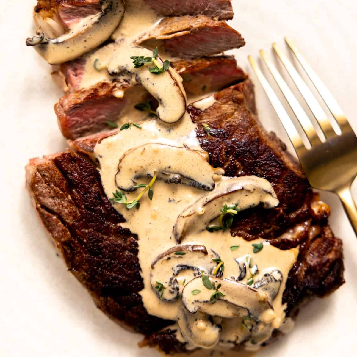 Steak served with a creamy mushroom sauce on top. 